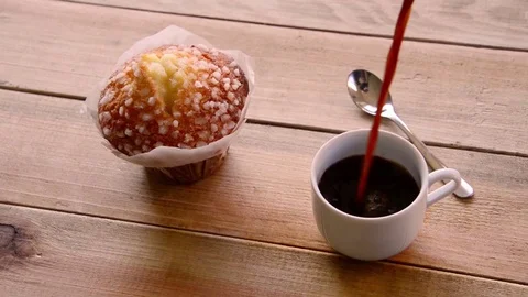 Seamless loop - Pouring coffee in a cup and muffin Stock Footage 73230173