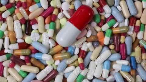 Seamless loop shot of rotating big pill on top of medication Stock Footage 280677635