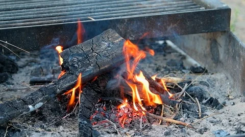 Seamless loop slow motion closeup of red flame on hot logs in fire pit grill Stock Footage 130073053