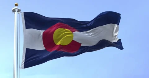 Seamless loop in slow motion of Colorado state flag waving on a clear day Video stock 243645408