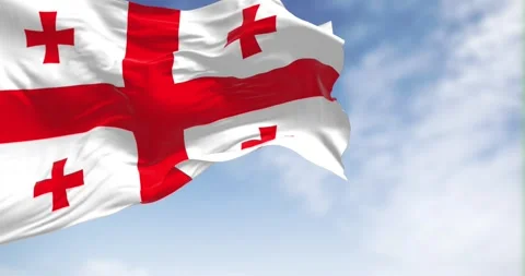 Seamless loop in slow motion of Georgian national flag waving on a clear day Stock Footage 240414174