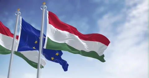 Seamless loop in slow motion of Hungary and the EU waving on a clear day Stock Footage 244455152