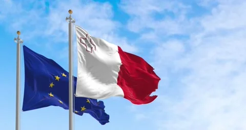 Seamless loop in slow motion of Malta and EU waving in the wind on a clear da Video stock 238991259