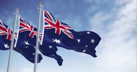 Seamless loop in slow motion of three Australia flags waving on a clear day Stock Footage 239639313