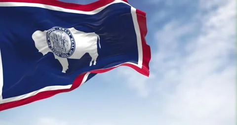 Seamless loop in slow motion of Wyoming state flag waving on a clear day Stock Footage 241415427