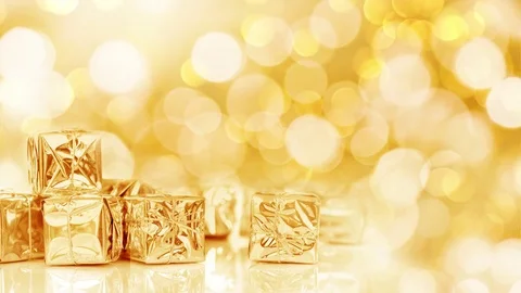 Seamless loop - small Christmas gifts in shiny golden paper, bokeh lights bac Stock Footage 81655352