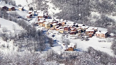Seamless loop - Snow falling on the village of Saint Martin de Belleville in Stock Footage 81655424