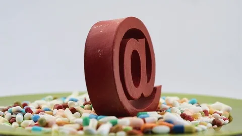 Seamless loop of spinning at sign among pills Stock Footage 97054298