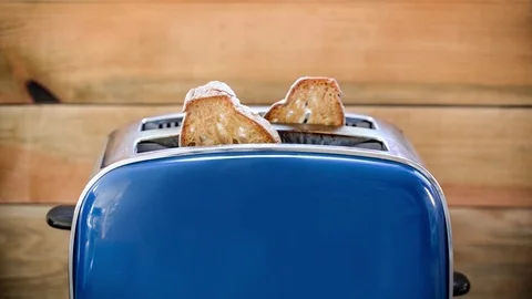 Seamless loop - Toast popping out of vintage blue toaster, wooden background Stock Footage 73620245