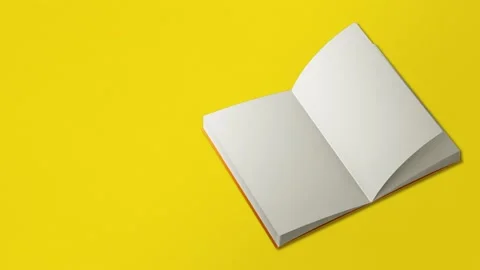 Seamless loop video. Book page flipping on yellow background. Concept Video stock 196210131