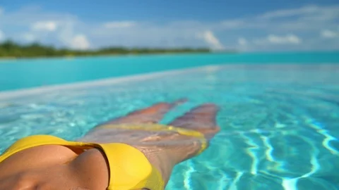 Seamless Loop video: Sexy bikini body woman relaxing swimming in luxury pool Video stock 117461617