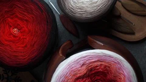 Seamless loop of yarn skeins and crochet hooks arranged in warm cozy setting Stock Footage 322177982