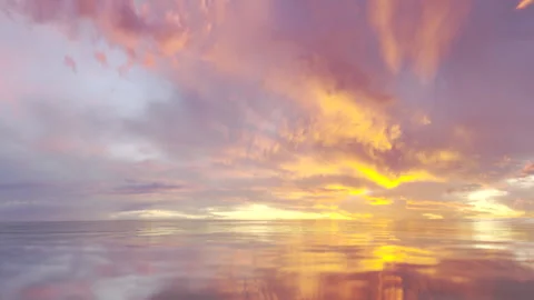 Seamless loopable golden sunset over soft waves in open sea Stock Footage 253566142