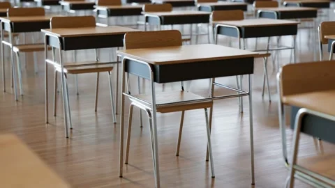 Seamless looping animation of endless rows of desks with chairs. Empty classroom Stock Footage 133464017