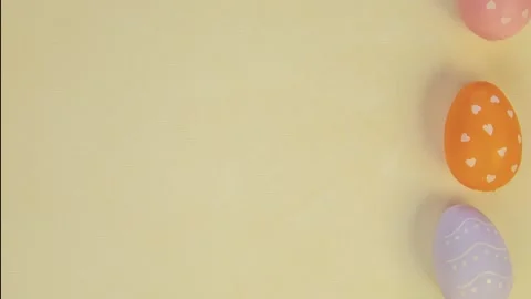 Seamless looping animation of multicolour Easter eggs on a yellow background Stock Footage 233182859
