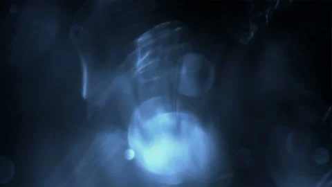 Seamless looping motion background shows a dark blue design and glowing bokeh Stock Footage 160670816