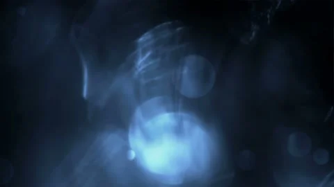 Seamless looping motion background shows a dark blue design and glowing bokeh Stock Footage 160670925