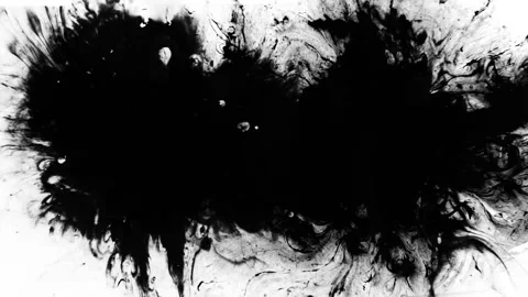 Seamless looping motion graphic shows a dynamic black ink background on white Stock Footage 160669677