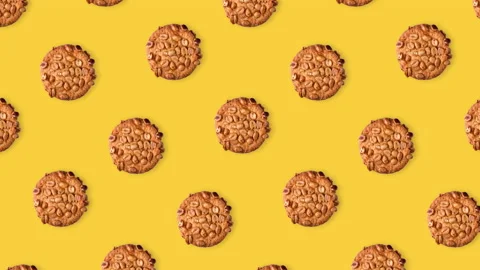 Seamless looping pattern animation of peanut cookies on a yellow background Stock Footage 141453858