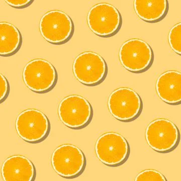 Seamless orange fruit pattern on orange background. Colorful fresh citrus slice Stock Photos