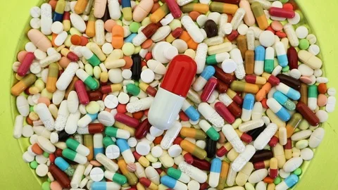 Seamless overhead loop of spinning plate of pills Stock Footage 97053968