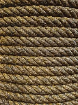 Seamless pattern and texture of brown dirty tightly twisted straw rope. Det.. Foto stock