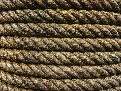 Seamless pattern and texture of brown dirty tightly twisted straw rope. Det.. Stock Photos