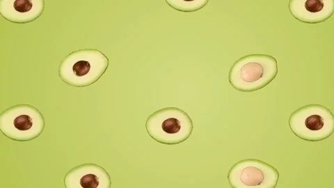 Seamless Pattern Animation of Fresh Avocado Halves on Green Background Video stock 334708335