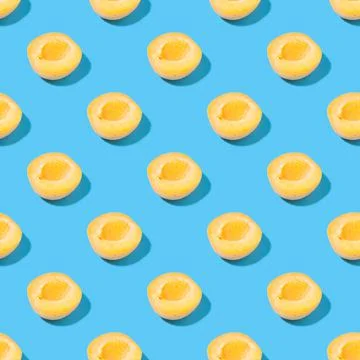 Seamless pattern of apricots on a blue background Stock Photos