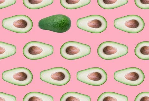 Seamless pattern with avocado on a coral background. Photo pattern with avocado Stock Photos