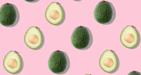 Seamless pattern with avocado on pink background. Stock Photos
