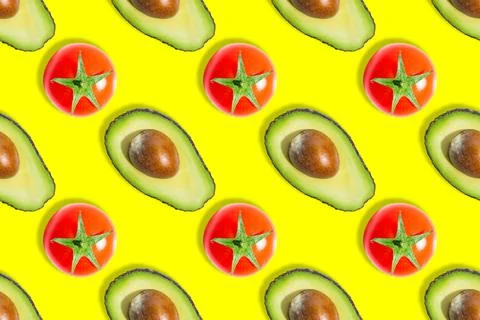 Seamless pattern of avocados and cherry tomatoes isolated on yellow background Stock Photos