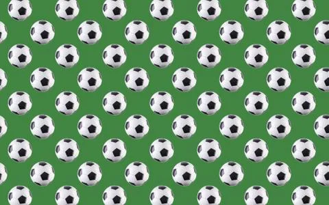 Seamless pattern of balls. Black and white soccer balls on green background. Stock Photos
