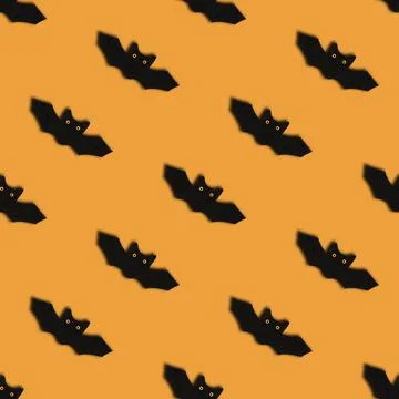 Seamless pattern with bats on orange background. Halloween abstract backgroun Stock Photos