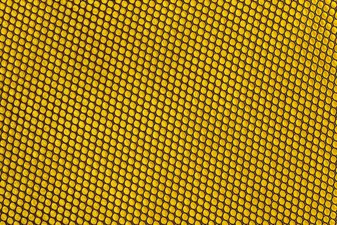 Seamless pattern of black fabric mesh on yellow background Stock Photos