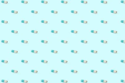 Seamless pattern with blue and white capsules, pills. Stock Illustration