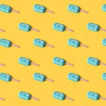 Seamless pattern blue mint ice cream popsicles on yellow background. Tasty an Stock Photos