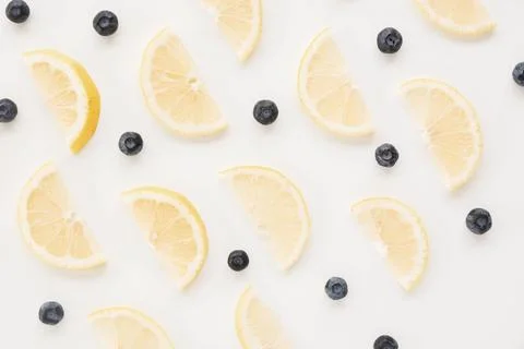 Seamless pattern blueberries lemon slices white backdrop Stock Photos