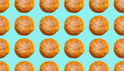 Seamless pattern with Burger buns that are sprinkled with sesame seeds on a t Stock Photos