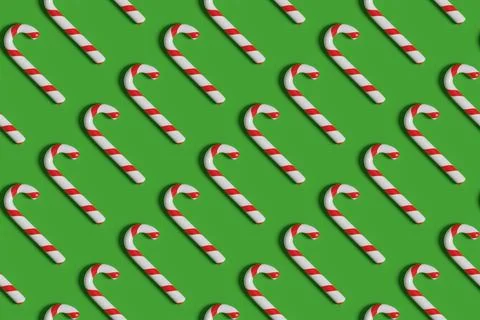Seamless pattern of candy canes on green background. Christmas background. .. 스톡 일러스트