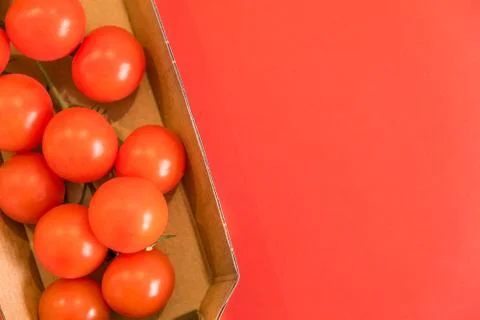 Seamless pattern with cherry tomatoes. Abstract background. Tomato on the red Stock Photos