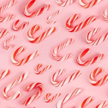 Seamless pattern of Christmas candy canes on pink background Stock Photos