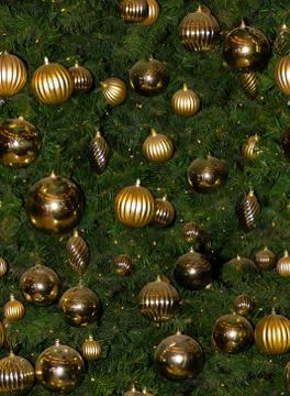 Seamless pattern of Christmas tree branches with gold toys. Close up Stock Photos