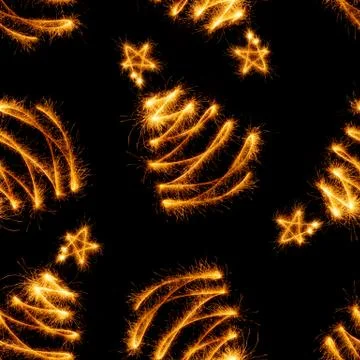 Seamless pattern of christmas trees made by sparkler on a black Stock Photos