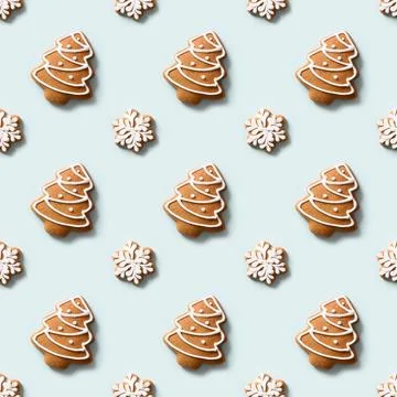 Seamless pattern of cookies in shape of snowflakes and Christmas tree on blue Stock Photos