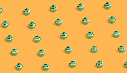 A seamless pattern of creepy human eyeball candies for Halloween against an o Stock Photos
