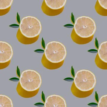 Seamless pattern with cut lemons and leaves on a gray background, hard shadow Stock Photos