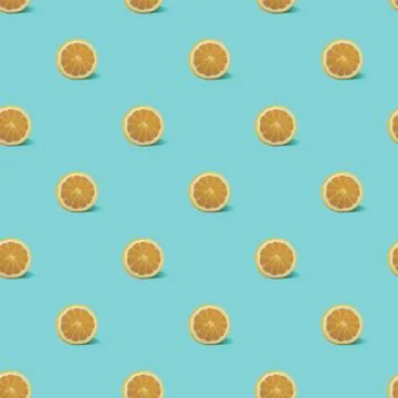Seamless pattern with cut lemons on a blue background Stock Photos