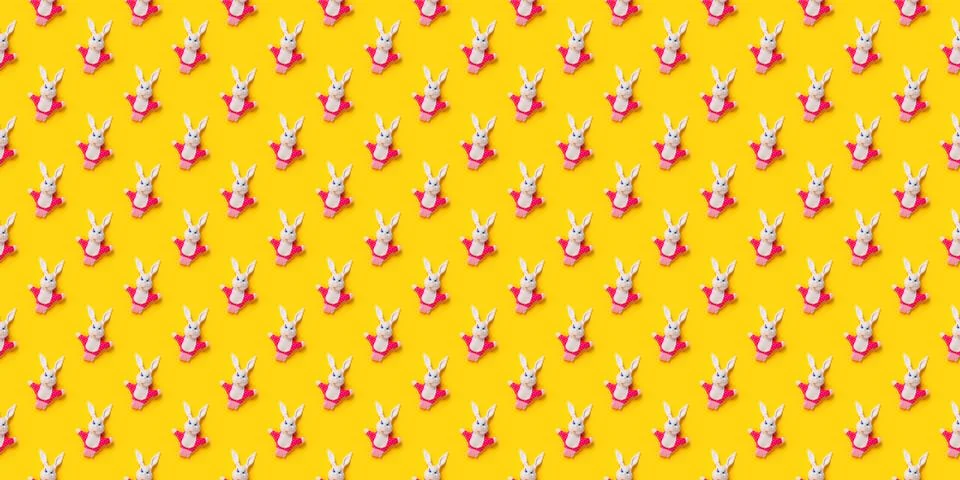 Seamless pattern. Easter bunnies isolated on yellow background. Funny texture 스톡 사진