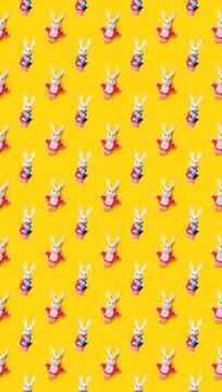Seamless pattern with Easter bunny and egg isolated on yellow background. Fun Stock Photos